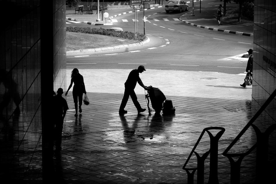 A janitor cleaning up the sidewalk